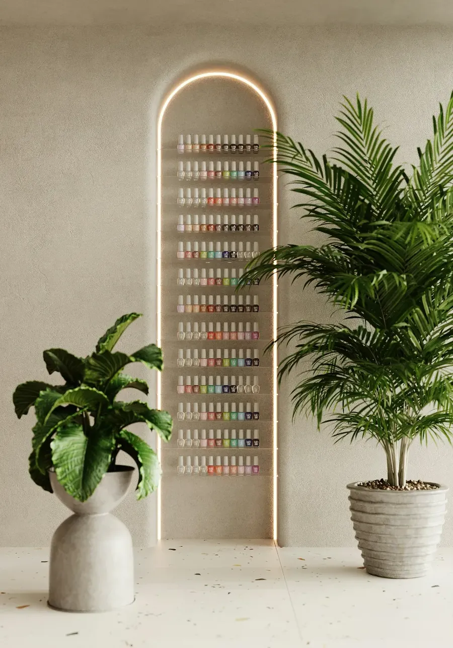 An arched display of nail colours between two plants